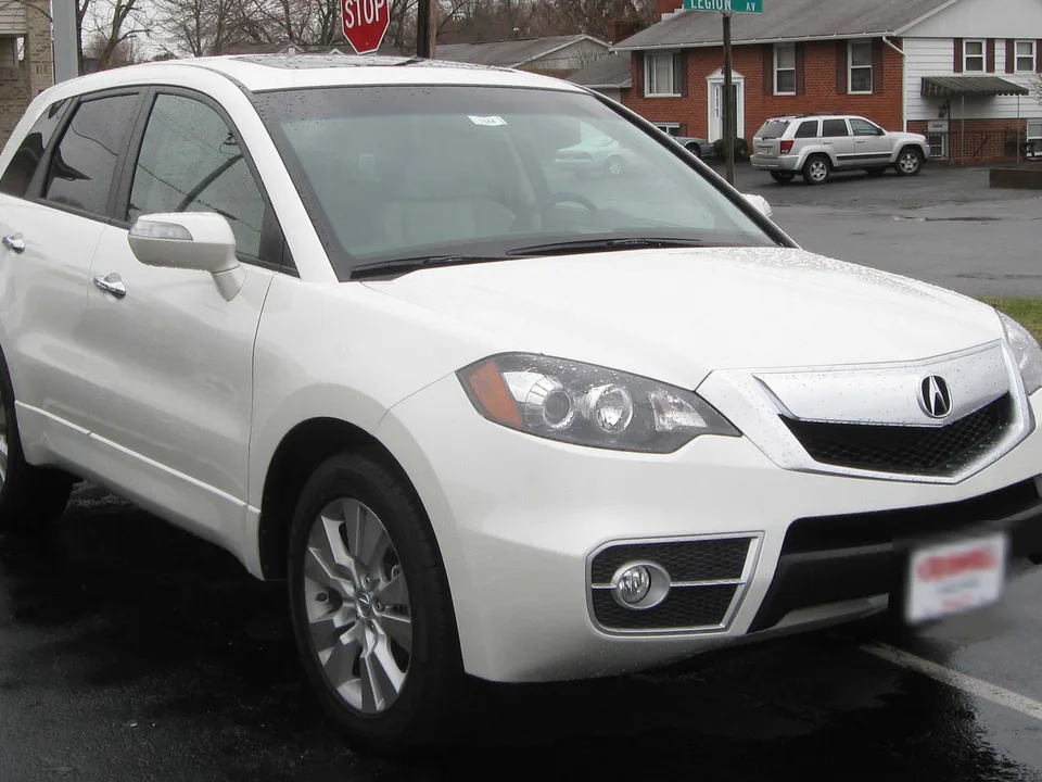 Acura RDX, front three-quarter on a wet lot — original