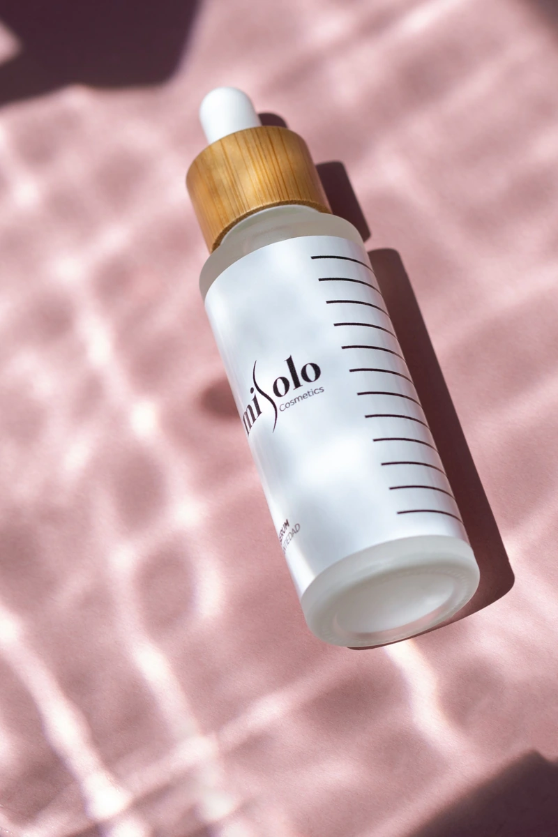 White serum bottle with a bamboo cap — original photo